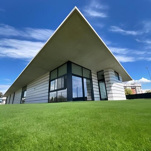 a white home surrounded by a vibrant artificial turf lawn